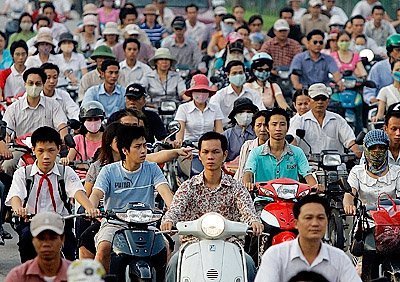 many people riding scooters in vietnam